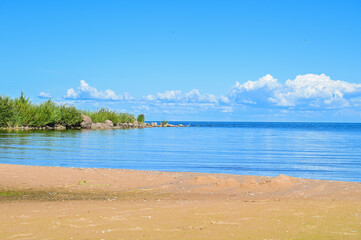 Summer view over the sandy beach to Lake Peipus (Peipsi-Pihkva järv) under a blue sky in summer near Kallaste, Tartu, Estonia