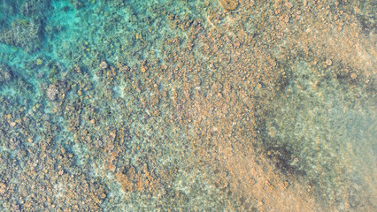 Aerial view of beautiful coral reef with turquoise sea water, natural background