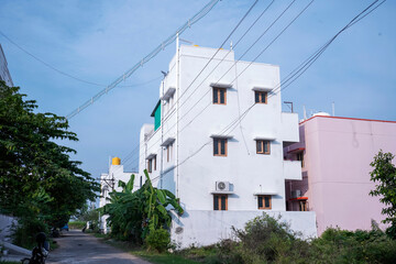 Cluster Of Electrical Wires With White Buliding On Sky Background