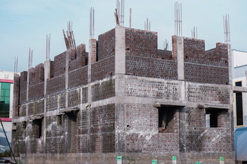 Under Construction House With Concreate Block On Red bricks with sky background