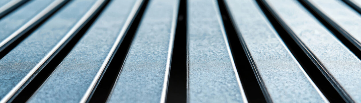 Close-up of metallic surface with parallel lines, depicting modern industrial design.
