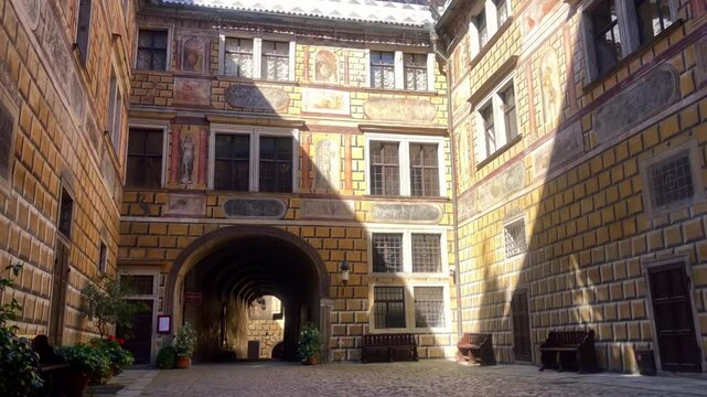 Castle courtyard with archway tunnel and cobblestone path. Medieval castle grounds. UNESCO. Cesky Krumlov Castle. Cesky Krumlov, Czech Republic. Europe.