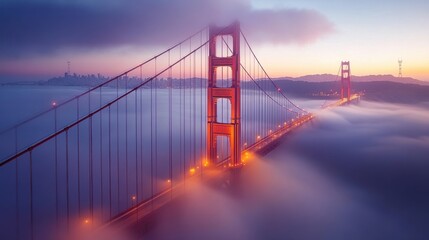 Obraz premium A serene misty morning view of the Golden Gate Bridge shrouded in fog with city skyline in the background