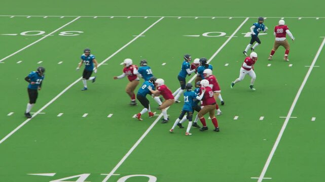 Players Preparing for a Match to Start. American Football Game with Athletes in Red and Blue Gear Sprinting Across the Turf, Coordinating Offensive and Defensive Strategies with Speed and Power