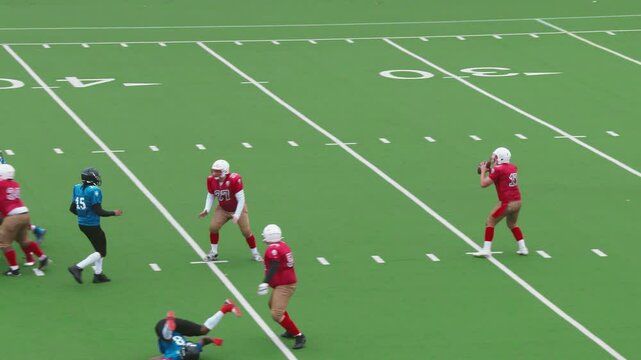Dynamic American Football Game with Diverse Male Athletes in Red and Blue Jerseys. Players Tackle for the Ball, Executing Strategic Plays. Team Celebrating When Scoring Points - Powered by Adobe