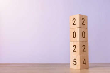 2024 change to 2025 wooden cube blocks on blue background. Resolution, plan, review, goal, start,...