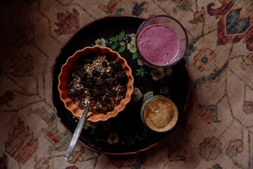 Health breakfast with smoothie and granola on bohemian background