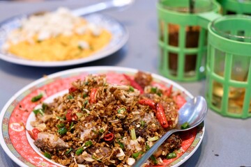 A dish of rice with stir-fried crab curry and chilli and salt fried pork belly at Chula 50 Kitchen in Silom, Bang Rak - Bangkok Thailand