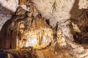 Stalactites and stalagmites illuminating postojna cave in slovenia