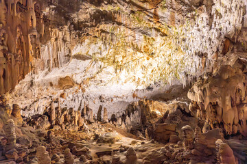 Stalactites and stalagmites illuminating postojna cave in slovenia