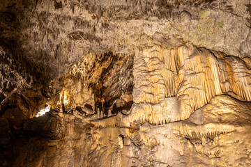 Stalactites and stalagmites growing in postojna cave, slovenia