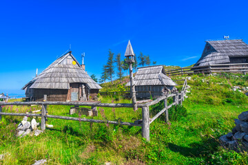 Traditional wooden houses overlooking logarska dolina valley in slovenia in summer © unai