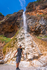 Tourist enjoying rinka waterfall in logarska dolina valley, slovenia © unai