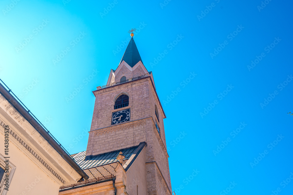 Wall mural Church tower reaching for the sky in kranj, slovenia