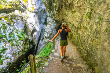Fototapeta premium Tourist walking down tolmin gorges canyon in slovenia during summer