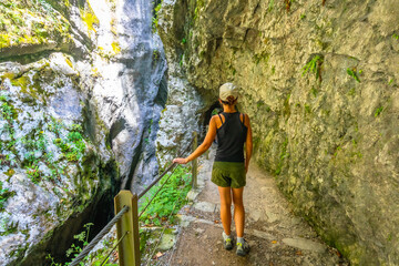 Fototapeta premium Tourist walking in tolmin gorges in slovenia during summer