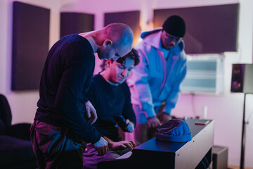 A diverse group of musicians working together in a recording studio, focused on creating music. The atmosphere is creative and collaborative, highlighting teamwork and artistry in an intimate setting.