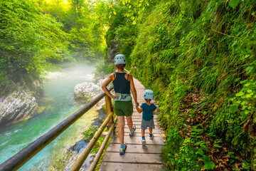 Mother and son exploring vintgar gorge in slovenia