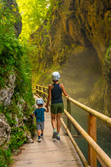 Mother and son exploring vintgar gorge in bled, slovenia