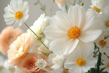 Fototapeta premium Beautiful array of white and peach flowers in a bright arrangement on a soft background