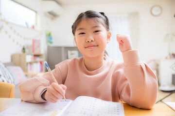 An elementary school girl smiling and studying for the camera Guts