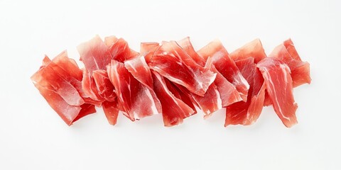 Thinly sliced jamon displayed on a white background, showcasing the delicate texture and rich color of jamon. This top view emphasizes the appeal of thinly sliced jamon for culinary uses.