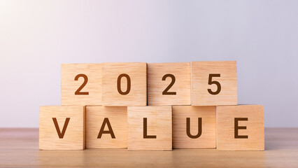 2025 Value on wooden blocks. Wooden blocks changing from 2024 to 2025. Business growth, goals, planning and New Year holiday concepts