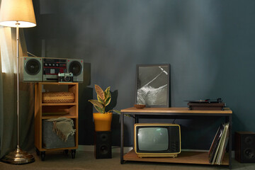 Retro tape recorder and tv standing in the room
