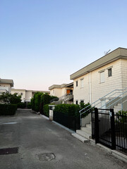 Residential street view of modern houses at sunset. Ippocampo, Italy.