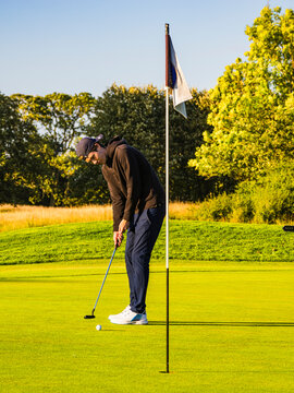 Young male golfer playing on golf course