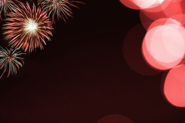 Red firework and blurred bokeh light with copy space in Christmas and New Year. Abstract background holiday concept.