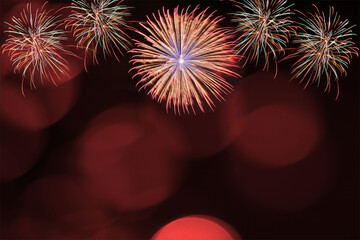 Red firework and blurred bokeh light with copy space in Christmas and New Year. Abstract background holiday concept.