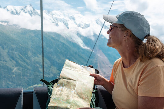 Woman holding map while traveling in hot air balloon