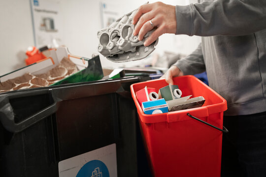 Midsection of mature man collecting garbage in bin