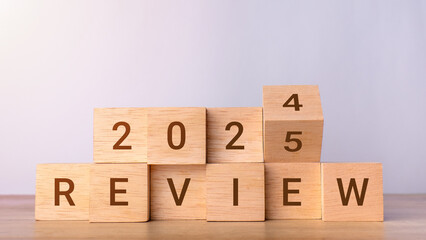 Review 2025. Flips wooden cube and changes words Review 2024 to Review 2025. Business growth,...