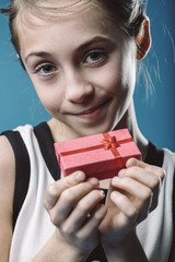 Smiling child holding a small gift box