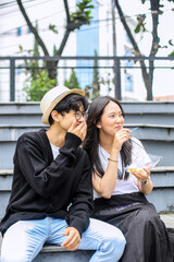 Happy Young Asian Couple Eating Street Food In Street Market