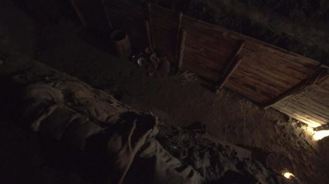 Top down perspective of a World war one soldier that runs through dark trenches, navigating the dangers of battle during a tense night in