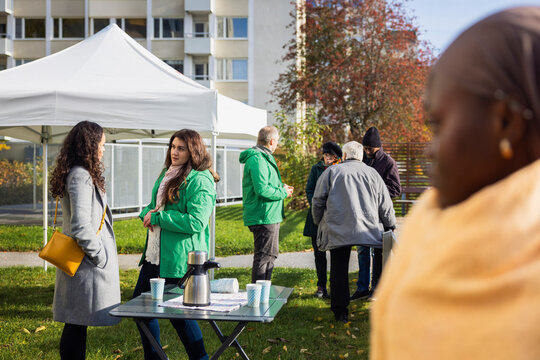 Group of volunteers helping people at park