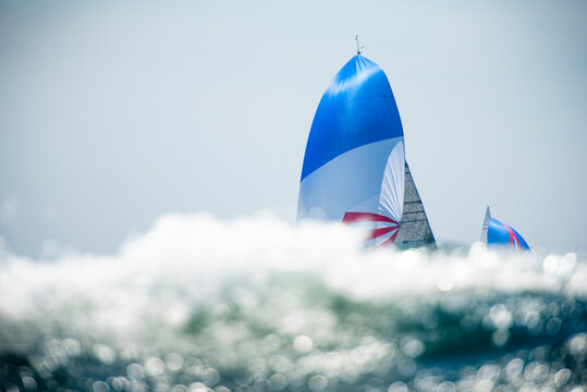 Boats sailing in a regatta with rushing Ocean Water