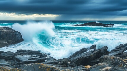 Obraz premium Dynamic Waves Crashing Against Rocky Coastline Under Dramatic Sky with Dark Clouds and Vivid Blue Water in Serene Seaside Landscape