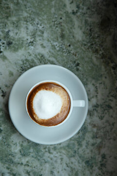 Directly above shot of frothy coffee on table