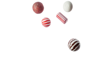 Christmas assorted holiday candies with peppermint and chocolate falling in the air isolated on background.