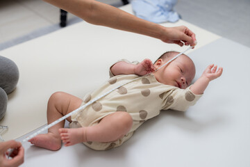 Measuring newborn baby height with tape