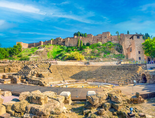 Remains of the ancient roiman theatre of Malaga right under the ruins of the Alcazaba palace towers and outer walls, Malaga, Andalusia (Andalucía), Spain