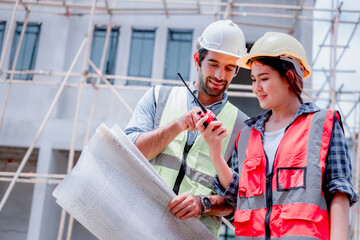 Engineering, blueprint. Structural engineer and architect working with blueprints discuss at the outdoors construction site..