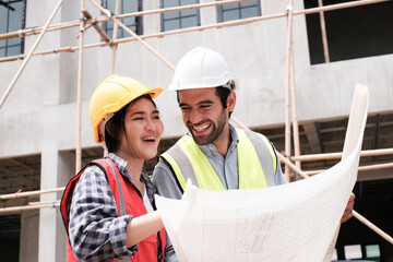 Engineering, blueprint. Structural engineer and architect working with blueprints discuss at the outdoors construction site..