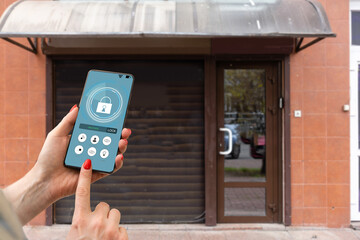 Cropped image of female entering secret key code for getting access and passing building using...