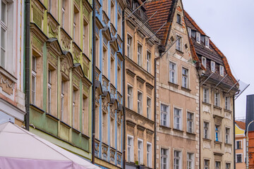 beautiful old historic tenement houses built in an arc along the street. colorful decorated tenement houses. old urban architecture, interesting place in the city.