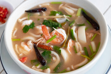 Spicy clear soup with fresh herbs 